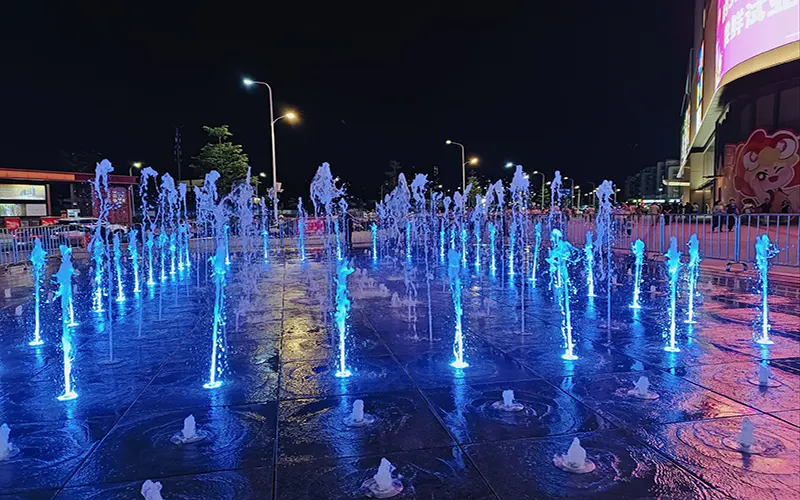 Outdoor LED fountain lights creating colorful water feature lighting effect
