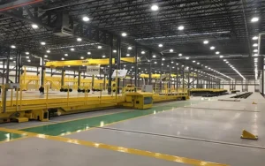 High Bay vs Low Bay Lighting comparison showing high bay lighting in a large industrial warehouse with high ceilings